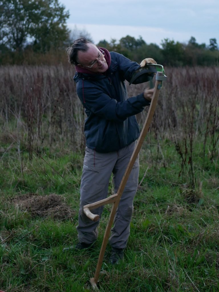 Alexis sharpening a scythe